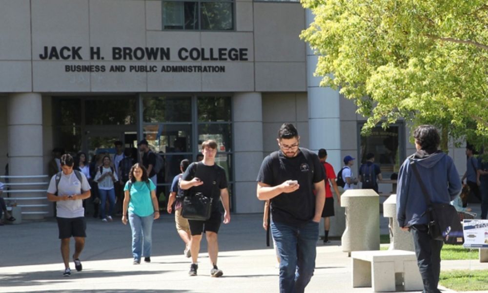 Students walking in front of Jack H. Brown College building